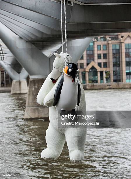 Suicide Penguins' by Taiwanese artist Vincent Huang hangs from the Millennium Bridge on February 13, 2010 in London, England. The installation is...