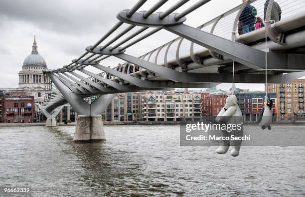Suicide Penguins' by Taiwanese artist Vincent Huang hangs from the Millennium Bridge on February 13, 2010 in London, England. The installation is...