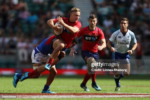 Vaa Apelu Maliko of Samoa tackles Harvey Elms of Scotland in their match for the 13th place during the HSBC London Sevens at Twickenham Stadium on...