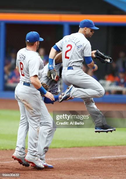 Tommy La Stella of the Chicago Cubs avoids a crash with Ian Happ and Jason Heyward who caught a foul ball against the New York Mets during their game...