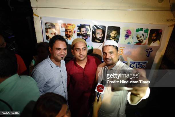People take selfies with Dr Kafeel Ahmed Khan at the Iftar party organised by Yashpal Saxena, father of Ankit Saxena organised an Iftar party at his...