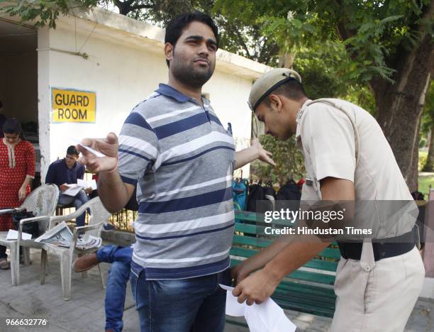 Policemen check UPSC aspirants before the Civil service Preliminary exams outside an examiantion center at Government Girls College, MG road on June...