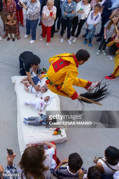 The 'Colacho' jumps over babies during 'El salto del Colacho', the baby jumping festival in the village of Castrillo de Murcia, near Burgos on June...