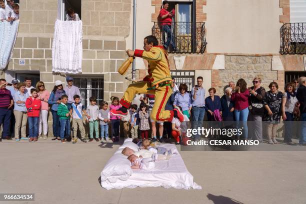 The 'Colacho' jumps over babies during 'El salto del Colacho', the baby jumping festival in the village of Castrillo de Murcia, near Burgos on June...