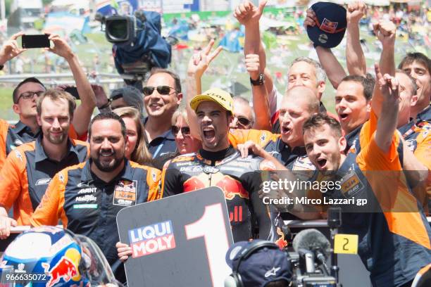 Miguel Oliveira of Portugal and Red Bull KTM Ajo celebrates the victory with team under the podium at the end of the Moto2 race during the MotoGp of...