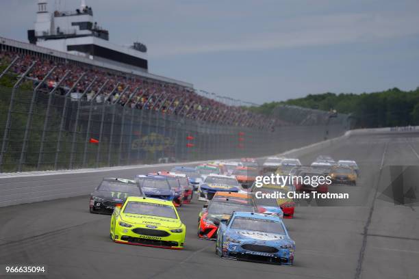 Ryan Blaney, driver of the Menards/Duracell Ford, and Kevin Harvick, driver of the Busch Beer Ford, lead the field to green for the start of the...