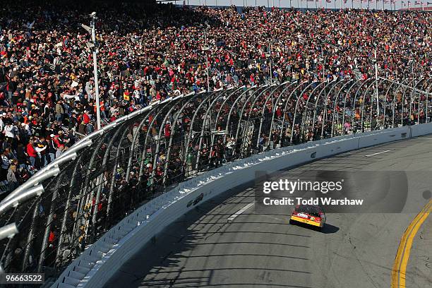 Tony Stewart, driver of the Ritz Crackers Chevrolet, waves to the crowd as he takes his victory lap after winning the NASCAR Nationwide Series...