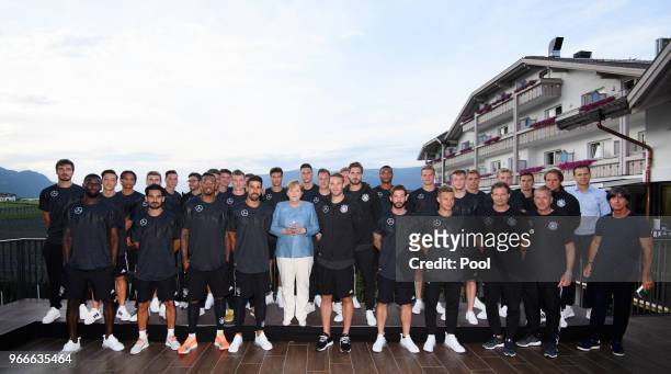 German Chancellor Angela Merkel poses with the German national team a during her visit at the Southern Tyrol Training Camp on day twelve on June 3,...
