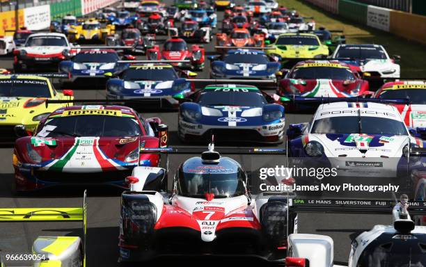 The Toyota Gazoo Racing TS050 Hybrid of Mike Conway, Kamui Kobayashi, Jose Maria Lopez, Fernando Alonso, and Anthony Davidson lines up with the other...