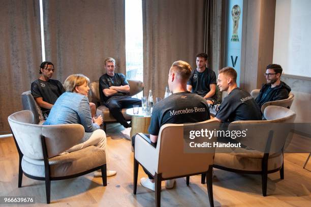 In this handout photo provided by the German Government Press Office , German Chancellor Angela Merkel talks to Leroy Sane, Julian Brandt, Marc-Andre...