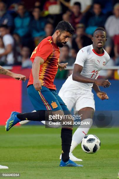 Spain's forward Diego Costa vies with Switzerland's midfielder Denis Zakaria during the international friendly football match between Spain and...