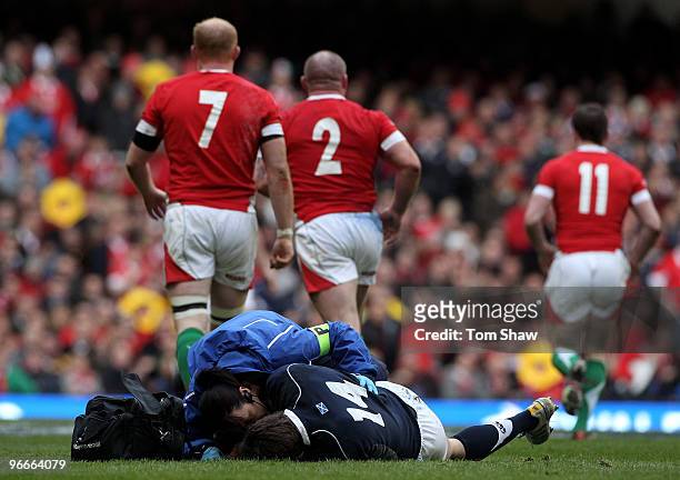 Thom Evans of Scotland receives treatment on the field during the RBS 6 Nations match between Wales and Scotland at the Millennium Stadium on...