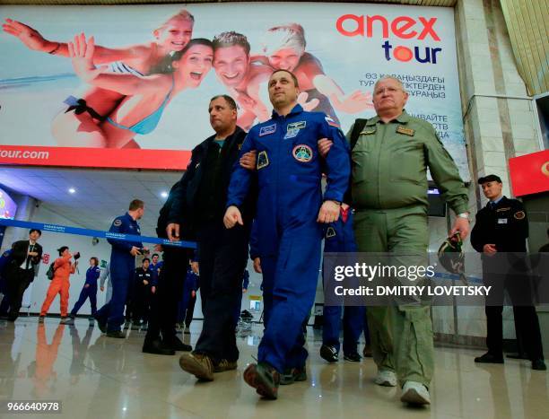 Russian space agency rescue team help Russian cosmonaut Anton Shkaplerov to walk after landing in the Russian Soyuz MS-07 space capsule, at...