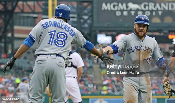 Russell Martin of the Toronto Blue Jays celebrates a solo home run with teammate Curtis Granderson of the during the sixth inning of the game against...