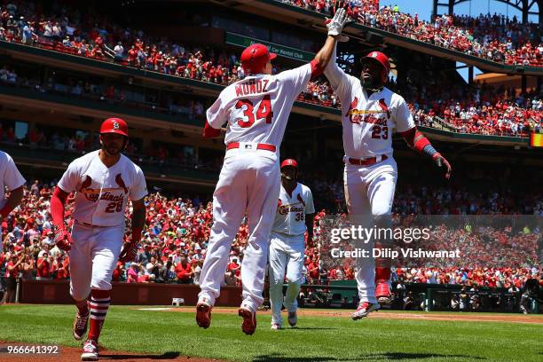 Marcell Ozuna of the St. Louis Cardinals celebrates after hitting a grand slam against the Pittsburgh Pirates in the first inning at Busch Stadium on...