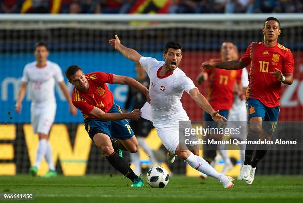 Cesar Azpilicueta of Spain competes for the ball with Blerim Dzemaili of Switzerland during the International Friendly match between Spain and...