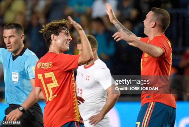 Spain's defender Alvaro Odriozola celebrates a goal with Spain's midfielder Thiago during the international friendly football match between Spain and...