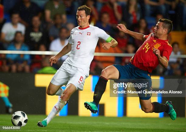 Cesar Azpilicueta of Spain competes for the ball with Stephan Lichtsteiner of Switzerland during the International Friendly match between Spain and...