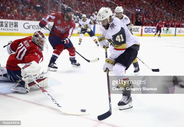 Braden Holtby of the Washington Capitals tends goal against Pierre-Edouard Bellemare of the Vegas Golden Knights in Game Three of the 2018 NHL...