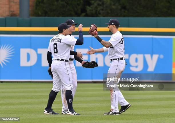 Mikie Mahtook, JaCoby Jones and Nicholas Castellanos of the Detroit Tigers celebrate the victory in game one of a double header against the Seattle...