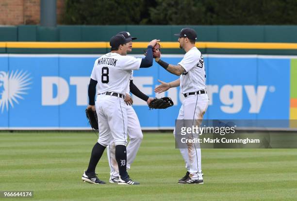 Mikie Mahtook, JaCoby Jones and Nicholas Castellanos of the Detroit Tigers celebrate the victory in game one of a double header against the Seattle...