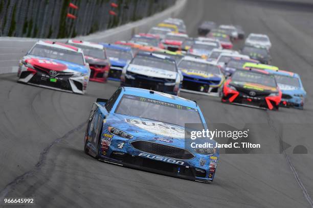 Kevin Harvick, driver of the Busch Beer Ford, leads a pack of cars during the Monster Energy NASCAR Cup Series Pocono 400 at Pocono Raceway on June...