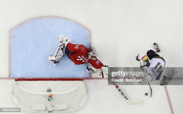 Braden Holtby of the Washington Capitals tends goal against Pierre-Edouard Bellemare of the Vegas Golden Knights in Game Three of the 2018 NHL...