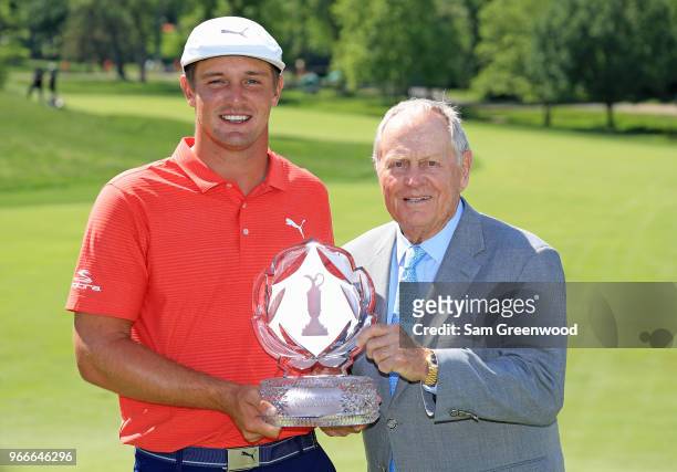 Bryson DeChambeau and Jack Nicklaus pose with the trophy after winning the The Memorial Tournament Presented by Nationwide at Muirfield Village Golf...