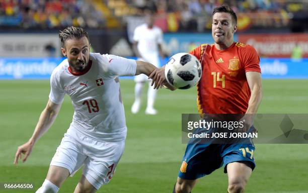 Spain's defender Cesar Azpilicueta vies with Switzerland's forward Josip Drmic during the international friendly football match between Spain and...