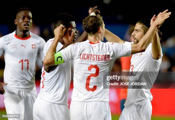Switzerland's defender Ricardo Rodriguez celebrates a goal with teammates during the international friendly football match between Spain and...