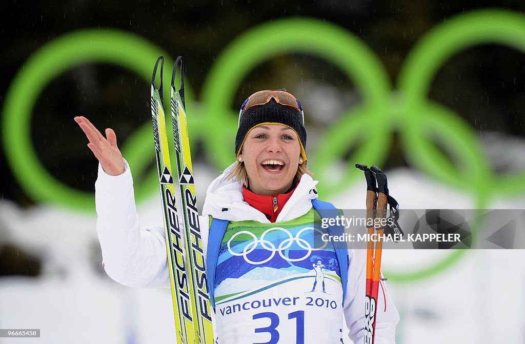 Germany's Magdalena Neuner celebrates pl