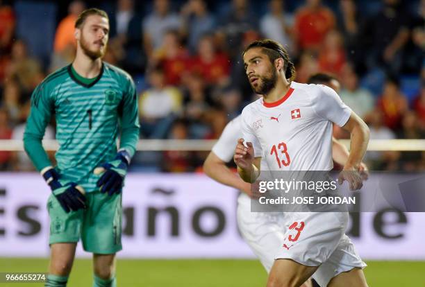 Switzerland's defender Ricardo Rodriguez celebrates a goal beside Spain's goalkeeper David de Gea during the international friendly football match...