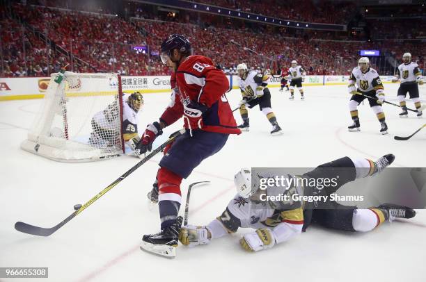 Jay Beagle of the Washington Capitals and Luca Sbisa of the Vegas Golden Knights battle for the puck in Game Three of the 2018 NHL Stanley Cup Final...