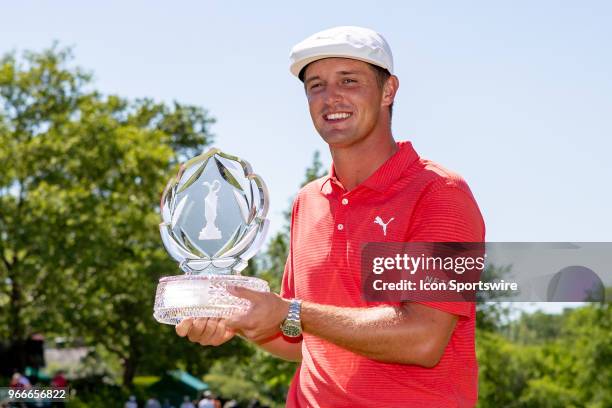 Bryson DeChambeau poses with the Memorial Tournament trophy after winning the second round playoff of the Memorial Tournament at Muirfield Village...