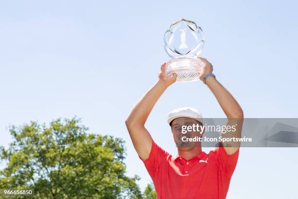 Bryson DeChambeau poses with the Memorial Tournament trophy after winning the second round playoff of the Memorial Tournament at Muirfield Village...
