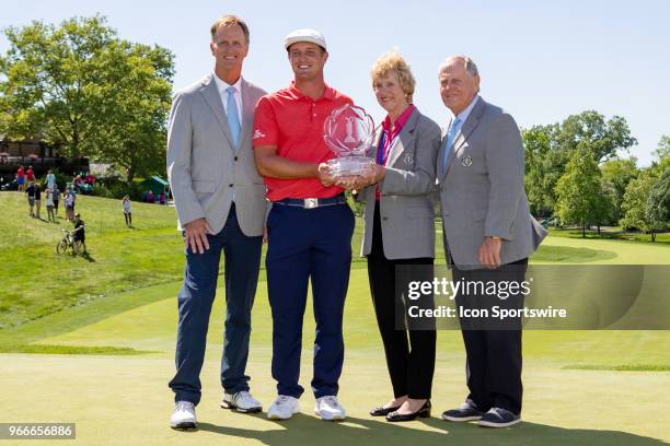 Bryson DeChambeau poses with the Memorial Tournament trophy after winning the second round playoff of the Memorial Tournament at Muirfield Village...