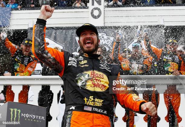 Martin Truex Jr., driver of the Bass Pro Shops/5-hour ENERGY Toyota, celebrates in Victory Lane after winning the Monster Energy NASCAR Cup Series...