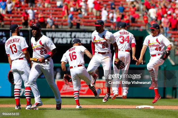 Marcell Ozuna, Tommy Pham, and Harrison Bader of the St. Louis Cardinals celebrate after defeating the Pittsburgh Pirates at Busch Stadium on June 3,...