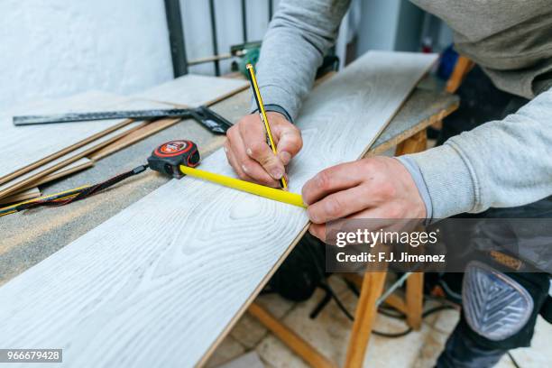 close-up of man measuring parquet floor - a j carpenter stock pictures, royalty-free photos & images