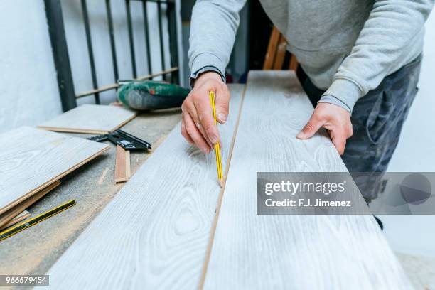 close-up of man measuring parquet floor - a j carpenter stock pictures, royalty-free photos & images