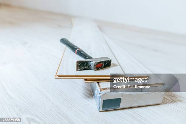 hammer on sheets of wood laminate floor - a j carpenter stock pictures, royalty-free photos & images