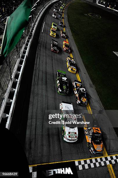 Jason White, driver of the Gunbroker.com Ford and Elliot Sadler, driver of the Hunt Brothers Pizza Chevrolet, lead the field into the start of the...