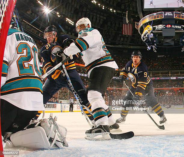 Derek Roy and Drew Stafford of the Buffalo Sabres look for the puck against Evgeni Nabokov and Dan Boyle of the San Jose Sharks on February 13, 2010...