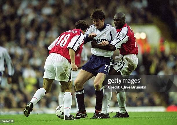 Darren Anderton of Spurs is challenged by Arsenal's Sol Campbell and Gilles Grimandi during the FA Barclaycard Premiership match between Tottenham...