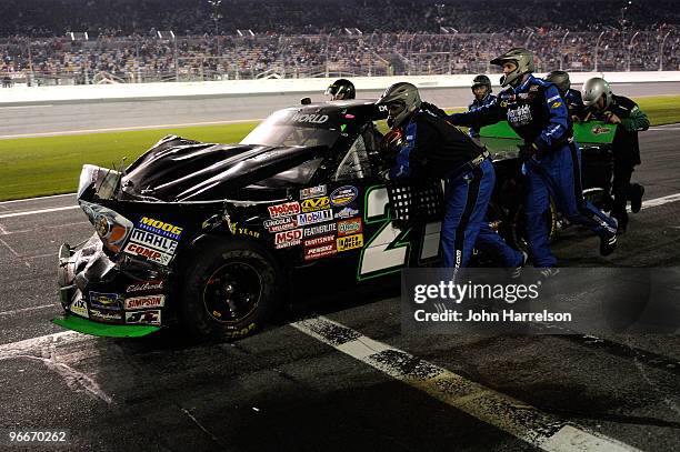 Donny Lia, driver of the ASI Limited/GunBroker.com Dodge, is pushed down pit row after being involved in an incident on track during the NASCAR...