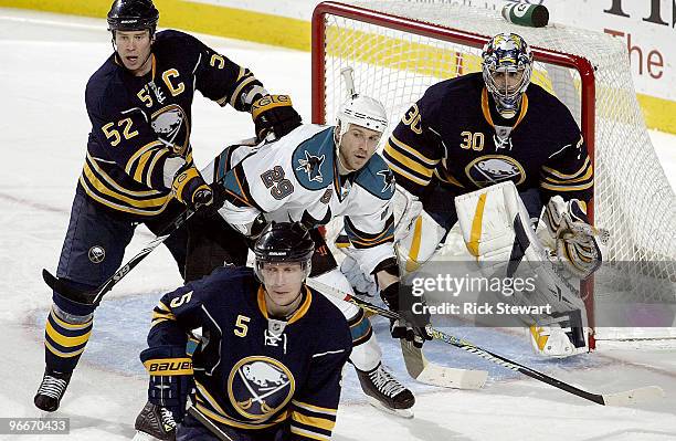 Craig Rivet Ryan Miller and Toni Lydman of the Buffalo Sabres surround Ryan Clowe of the San Jose Sharks at HSBC Arena on February 13, 2010 in...