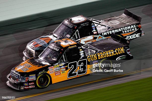 Jason White, driver of the Gunbroker.com Ford races Mike Skinner, driver of the International Trucks/Monaco RV Toyota, during the NASCAR Camping...