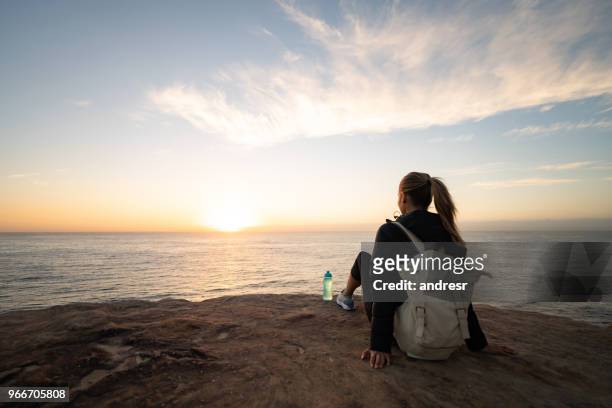 beautiful woman hiking and looking at the sunrise - top of the mountain australia stock pictures, royalty-free photos & images