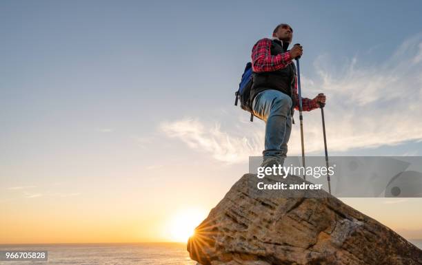 man hiking and standing at the top of the mountain - top of the mountain australia stock pictures, royalty-free photos & images