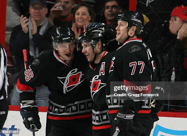 Ray Whitney of the Carolina Hurricanes celebrates his second period goal with teammates Jussi Jokinen and Joe Corvo during a NHL game against the New...